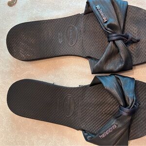Black Havaianas slip- on sandals.